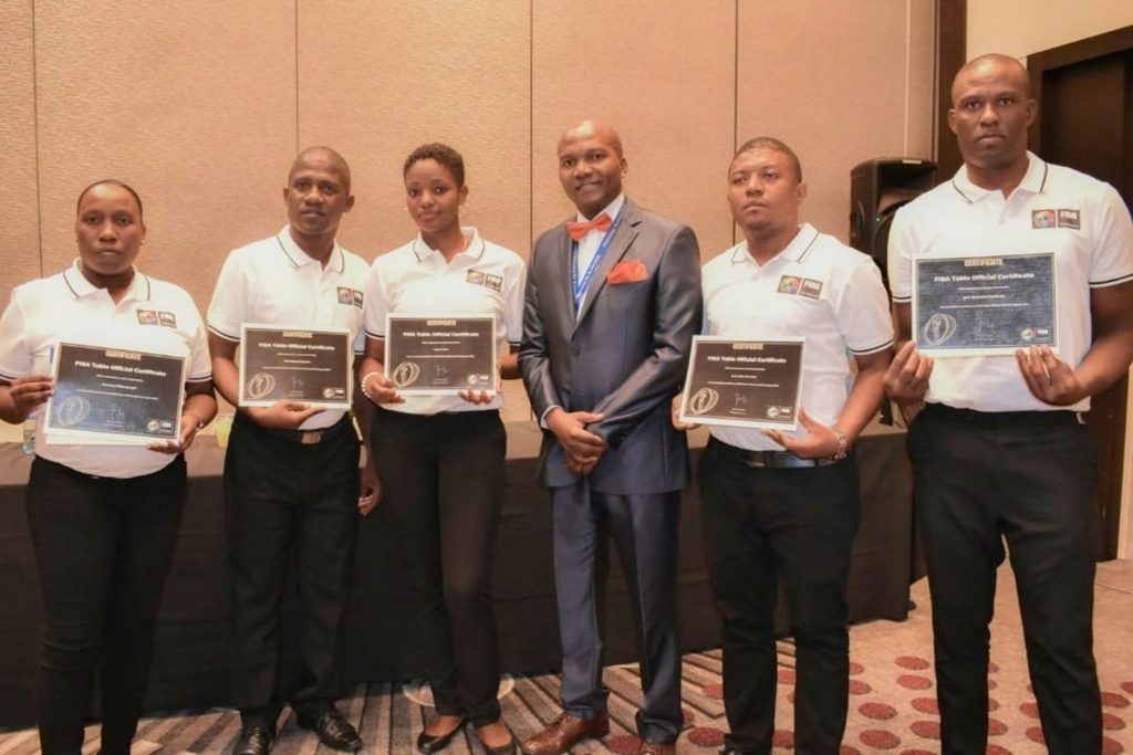 Basketball officials trained by IBOA displaying their FIBA certifications.